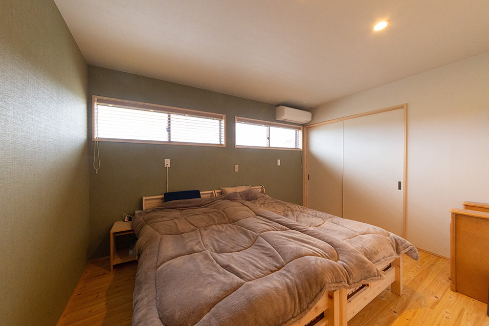 光を取り込みつつ外からの視線を遮る横長の窓と、木の香りでリラックスできる穏やかな寝室